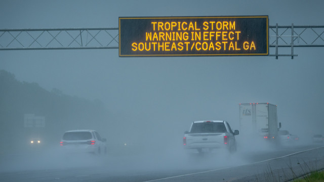 Vehicles pass under a tropical storm warning sign in effect due to tropical storm Debby in Waverly, Georgia, USA, 05 August 2024